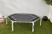 Acon 55in Trampoline Hexagon displayed on a lawn next to a water bottle and ball