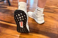 A person's feet posed to show the bottom of the Adidas Women's Ultraboost 1.0 Shoe