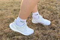 A close-up of the Adidas Women's Ultraboost 1.0 Shoes worn in grass