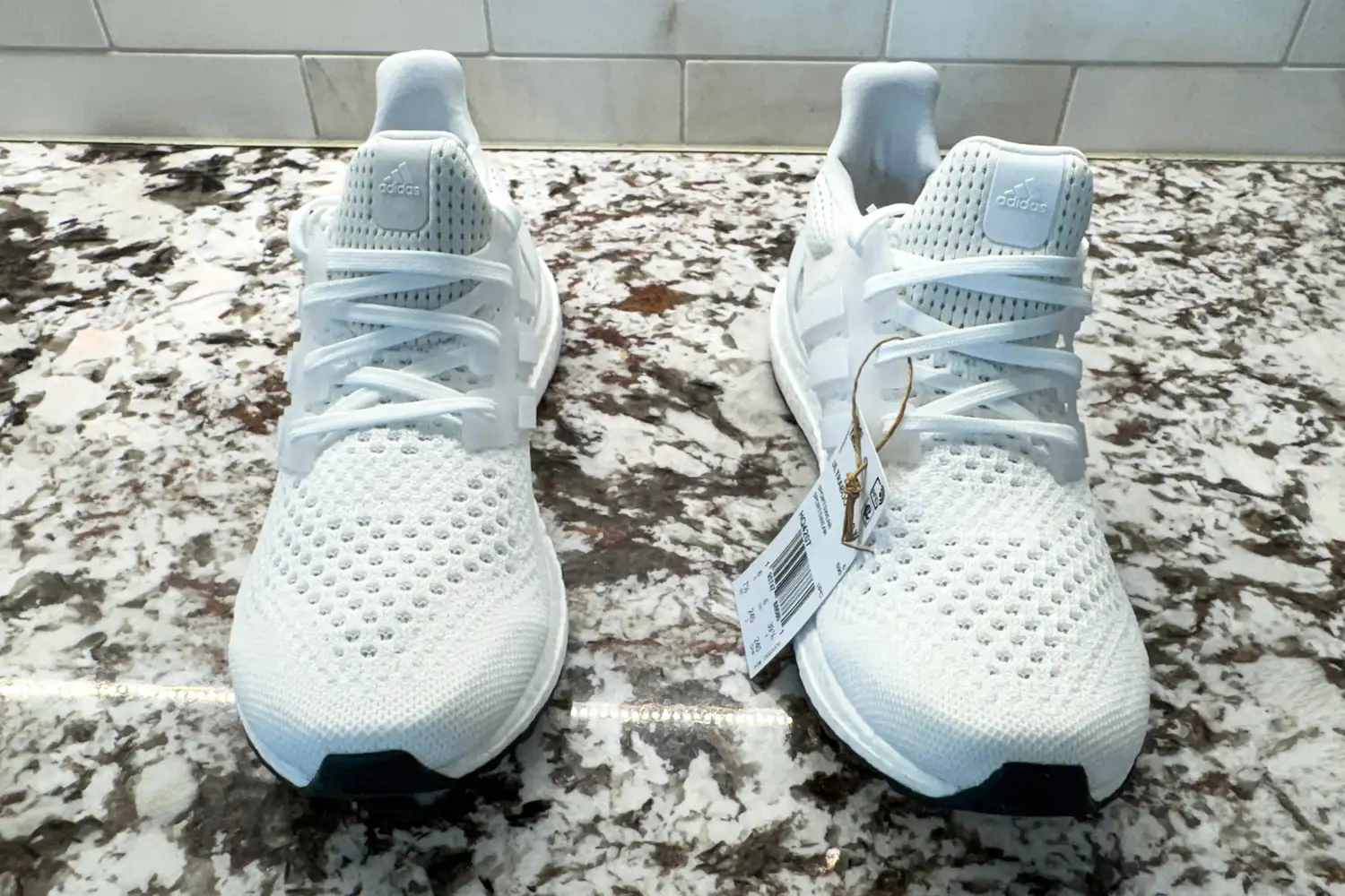 The Adidas Women's Ultraboost 1.0 Shoes with tags on a counter