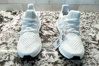The Adidas Women's Ultraboost 1.0 Shoes with tags on a counter
