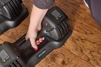 A person lifts up the All in Motion 25 lb Adjustable Dumbbell