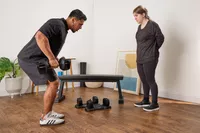 A person lifts the All in Motion 25 lb Adjustable Dumbbell