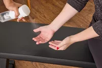 A person prepares to lift the All in Motion 25 lb Adjustable Dumbbells