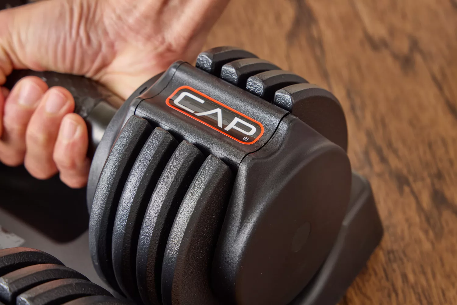 The logo on the side of the CAP Barbell 25 lb. Adjustable Dumbbell