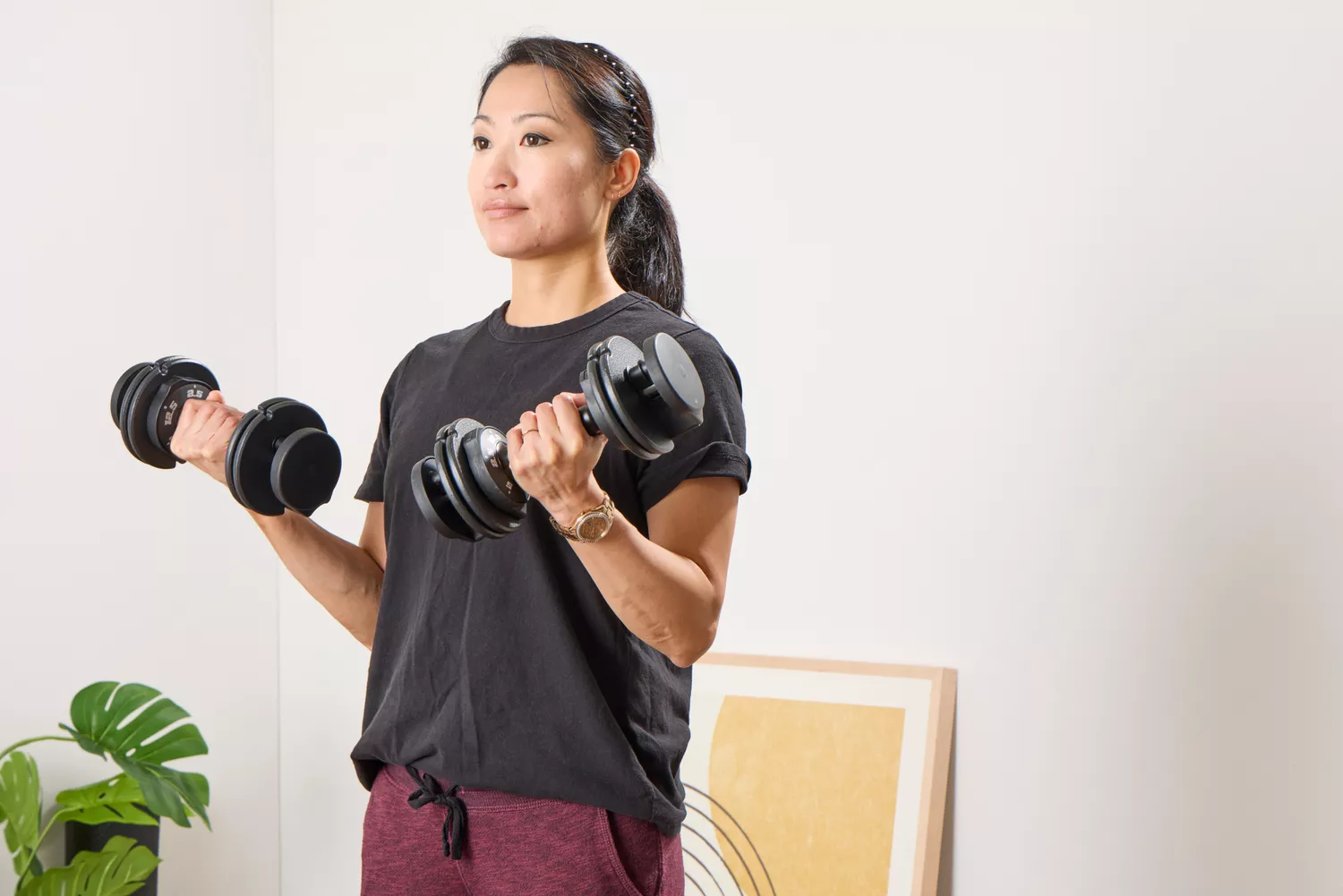 A person lifts up the CAP Barbell 25 lb. Adjustable Dumbbells