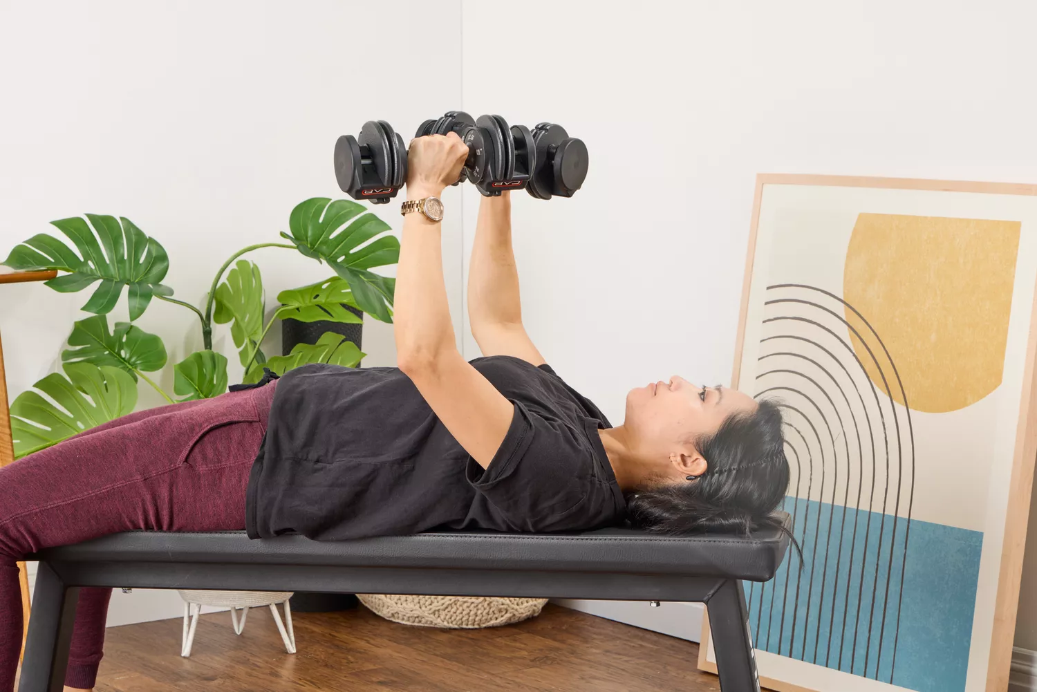 A person lifts the CAP Barbell 25 lb. Adjustable Dumbbell