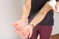 A person prepares to lift the CAP Barbell 25 lb. Adjustable Dumbbell