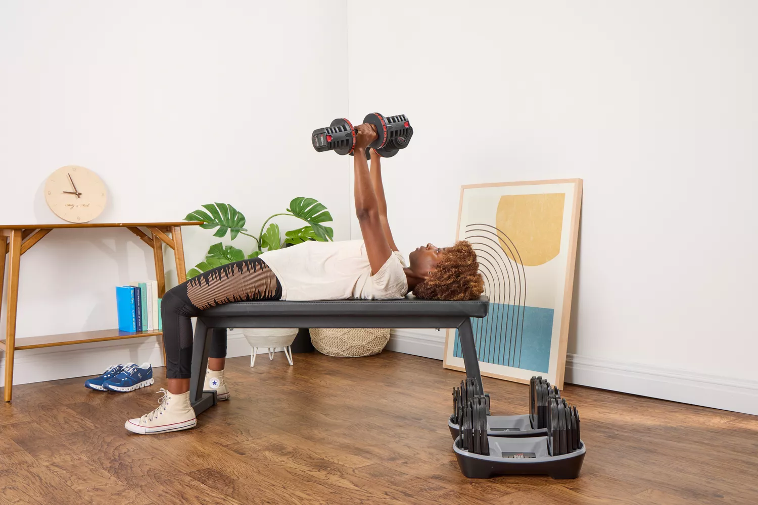 A person lifts the Non Zero Gravity 55 lbs PowerDyne Adjustable Dumbbells