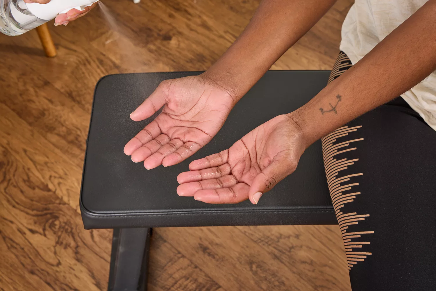 A person prepares to lift the Non Zero Gravity 55 lbs PowerDyne Adjustable Dumbbells