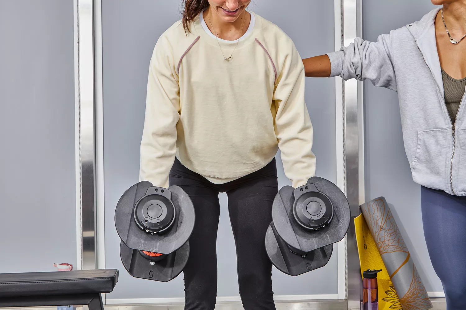 Person lifting FitRx SmartBells Set Quick Select Adjustable Dumbbells