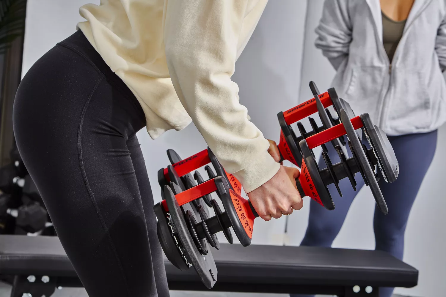 Person lifting FitRx SmartBells Set Quick Select Adjustable Dumbbells