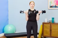 A person does arm curls using the Lifepro PowerFlow Plus Adjustable Dumbbell Set