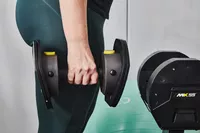 Person holding a MX55 Rapid Change Adjustable Dumbbell