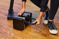 A person adjusts the weight on the POWERBLOCK Elite EXP Adjustable Dumbbell