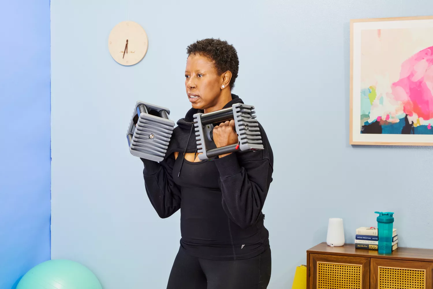 A person does arm curls using the POWERBLOCK Elite EXP Adjustable Dumbbells