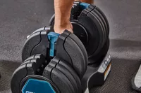 Hand preparing to pick up the ProForm Select-a-Weight Adjustable Dumbbells