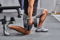Person doing a lunge with the ProForm Select-a-Weight Dumbbells