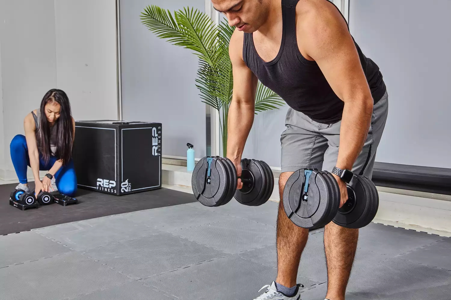 Person lifting ProForm Select-a-Weight Dumbbells