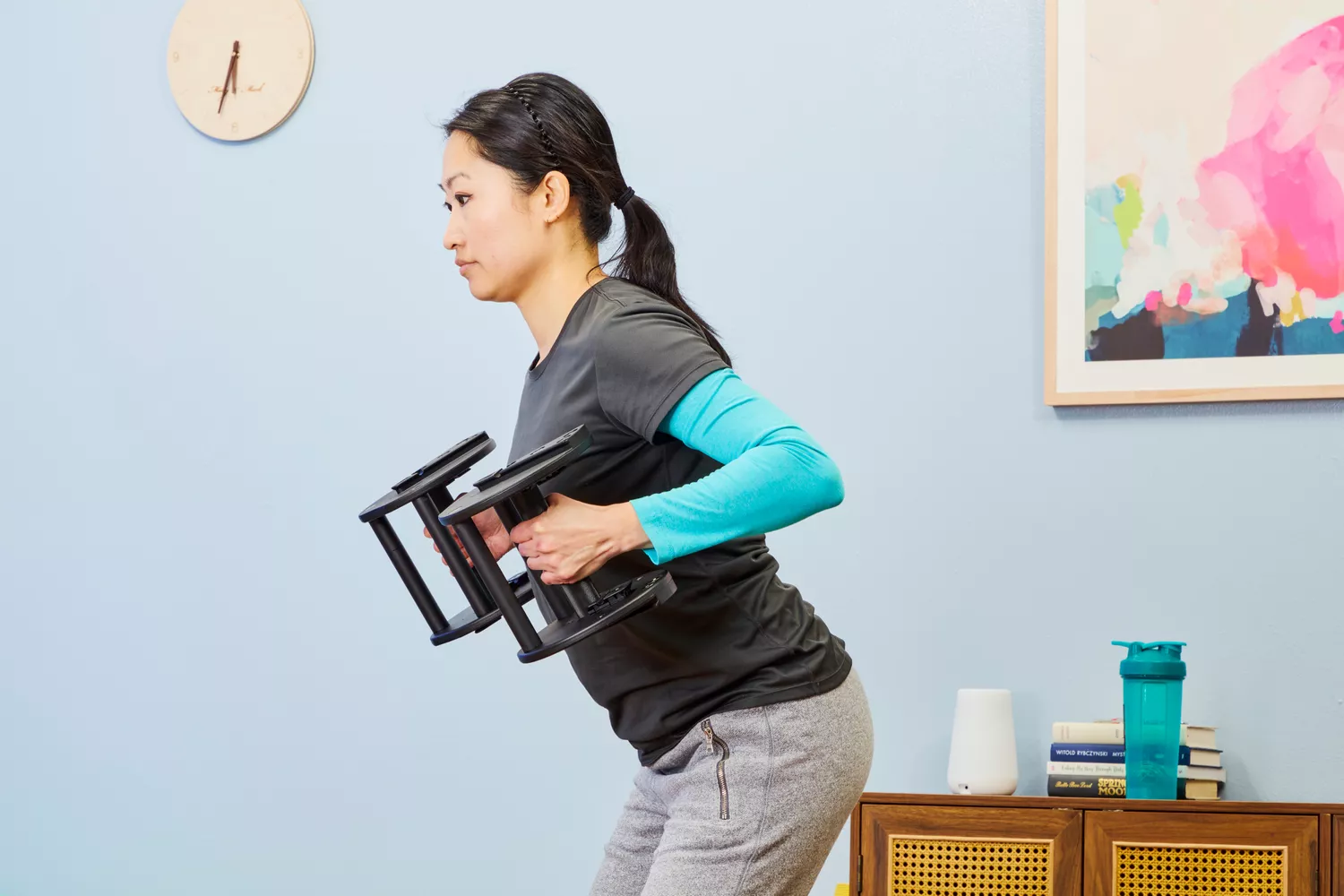 A person does chest presses while holding the Rep Fitness Quickdraw Adjustable Dumbbells