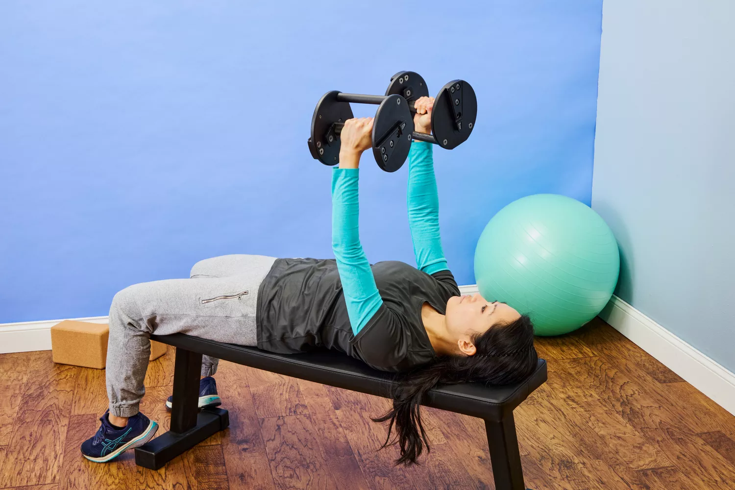 A person lifts the Rep Fitness Quickdraw Adjustable Dumbbells