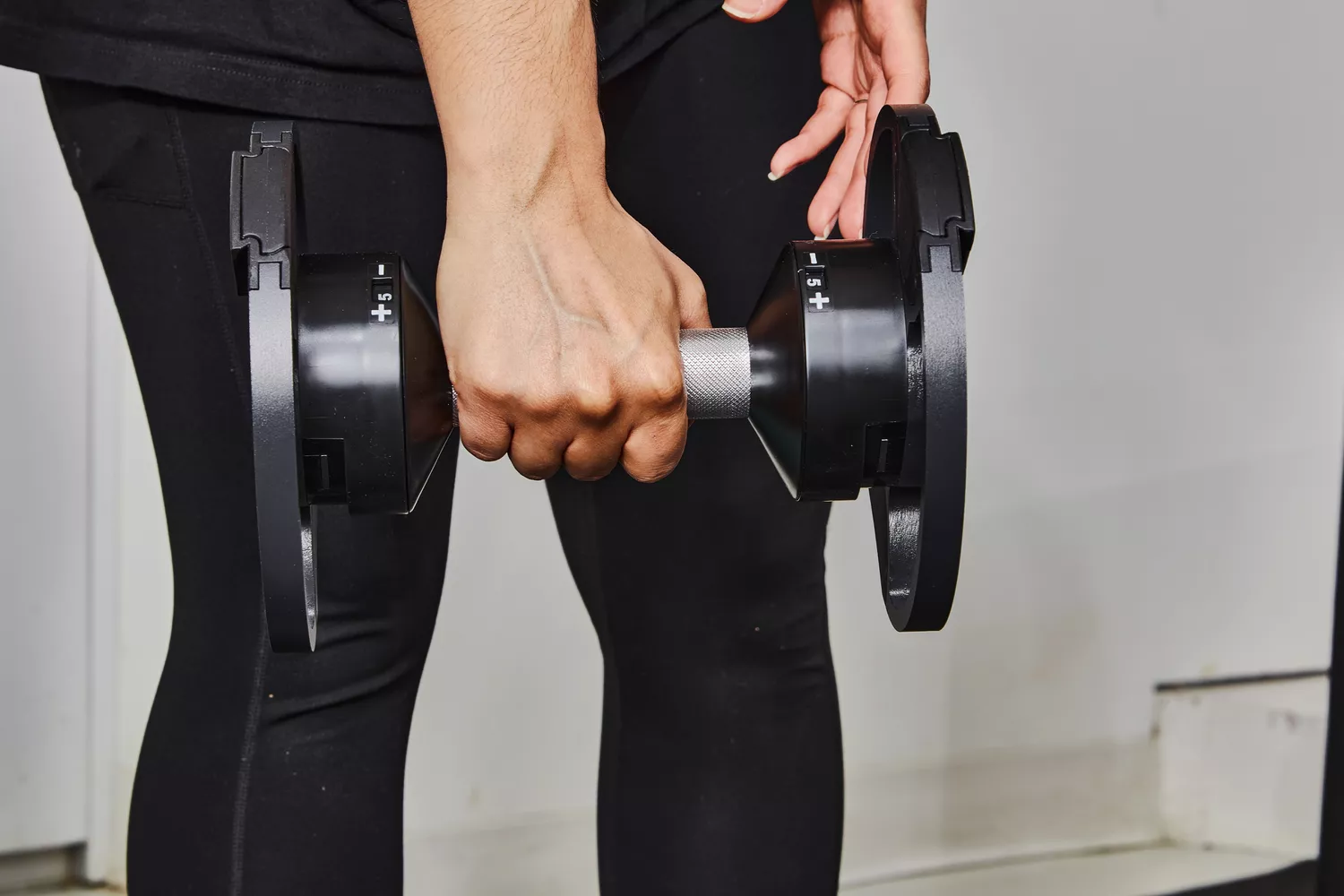 Hand holding Nuobell Adjustable Dumbbell