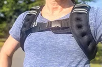A person wearing a blue top and Aduro Sport Adjustable Weighted Vest outdoors