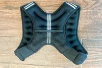 Aduro Sport Adjustable Weighted Vest for workouts shown on a wooden floor