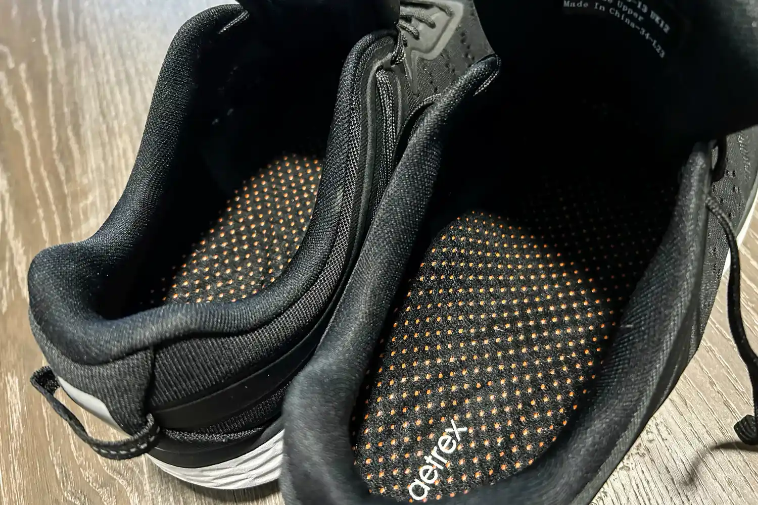 The interior and insoles of a pair of Aetrex Chase Arch Support Sneakers