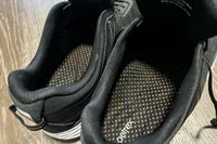 The interior and insoles of a pair of Aetrex Chase Arch Support Sneakers