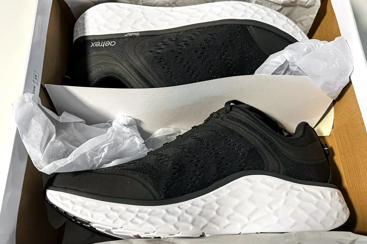 A pair of Aetrex Chase Arch Support Sneakers in a shoebox