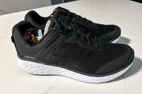 A pair of Aetrex Chase Arch Support Sneakers on a white surface