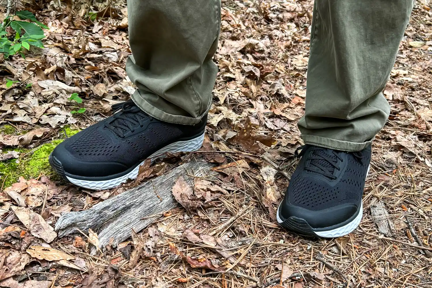 A person wearing Aetrex Chase Arch Support Sneakers walking on a forest trail