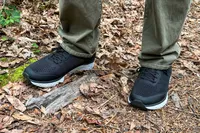 A person wearing Aetrex Chase Arch Support Sneakers walking on a forest trail