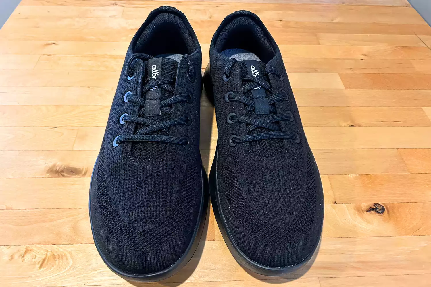 An overhead view of the Allbirds Men's Tree Runner Go on wood
