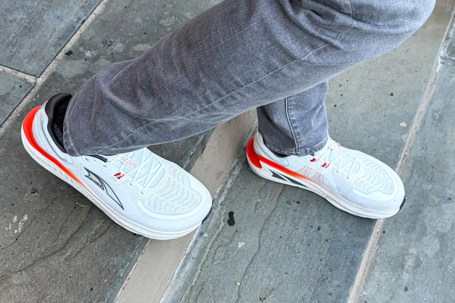 A person walks outside while wearing the Altra Men's Paradigm 7 Sneakers
