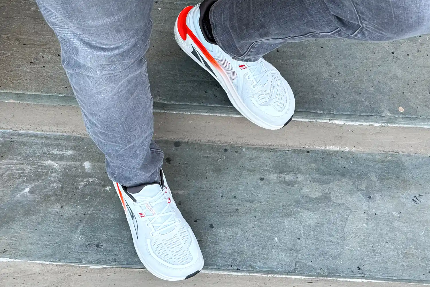 A person walking down steps wearing the Altra Men's Paradigm 7 Sneakers