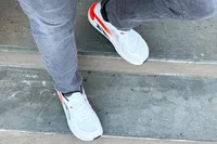 A person walking down steps wearing the Altra Men's Paradigm 7 Sneakers