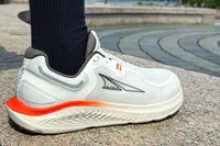 A person wears the Altra Men's Paradigm 7 Sneakers while walking outside
