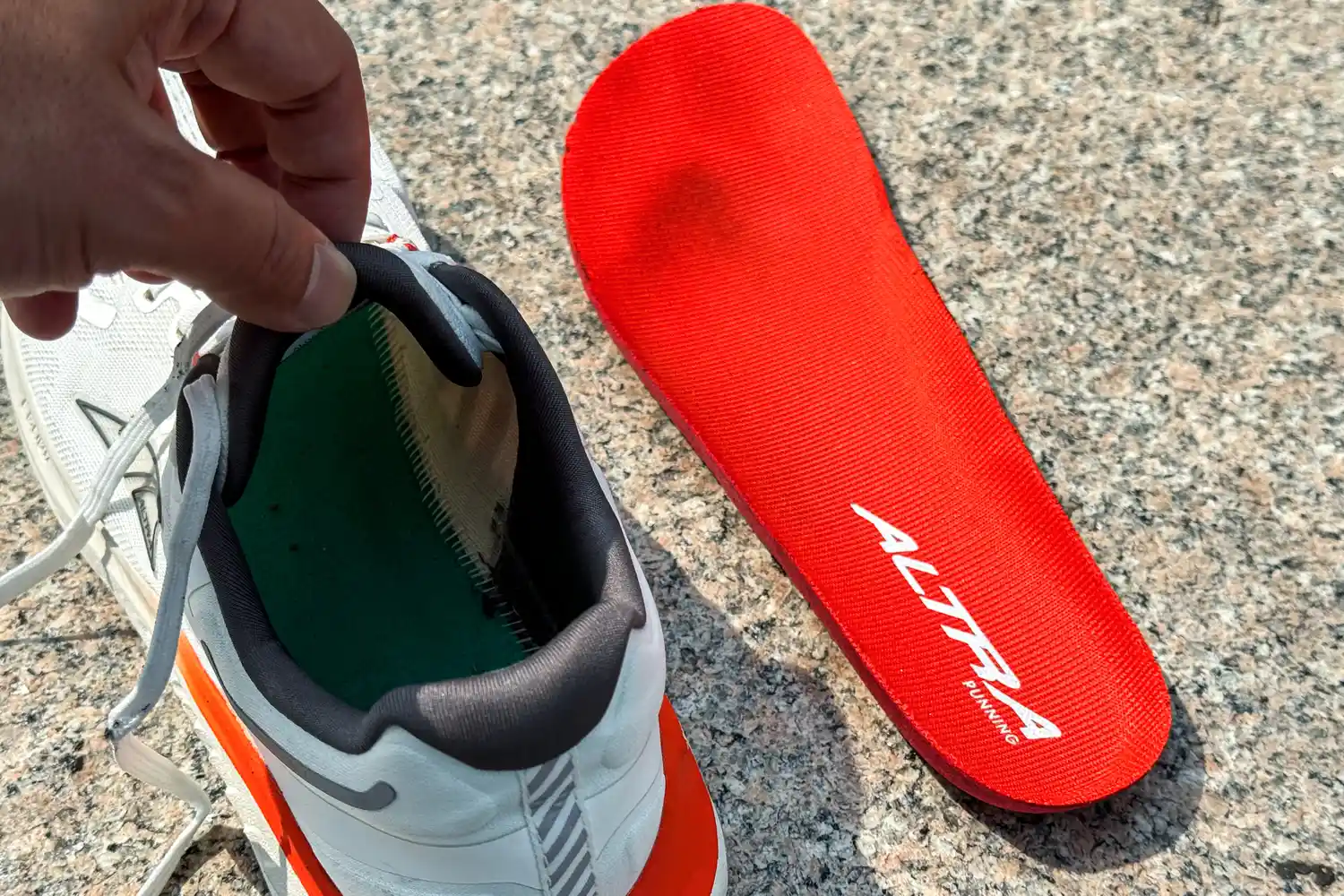 The insole removed and placed next to the Altra Men's Paradigm 7 Sneakers