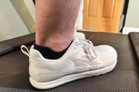 A close-up of the Altra Men's Solstice XT 3 sneaker worn on a treadmill