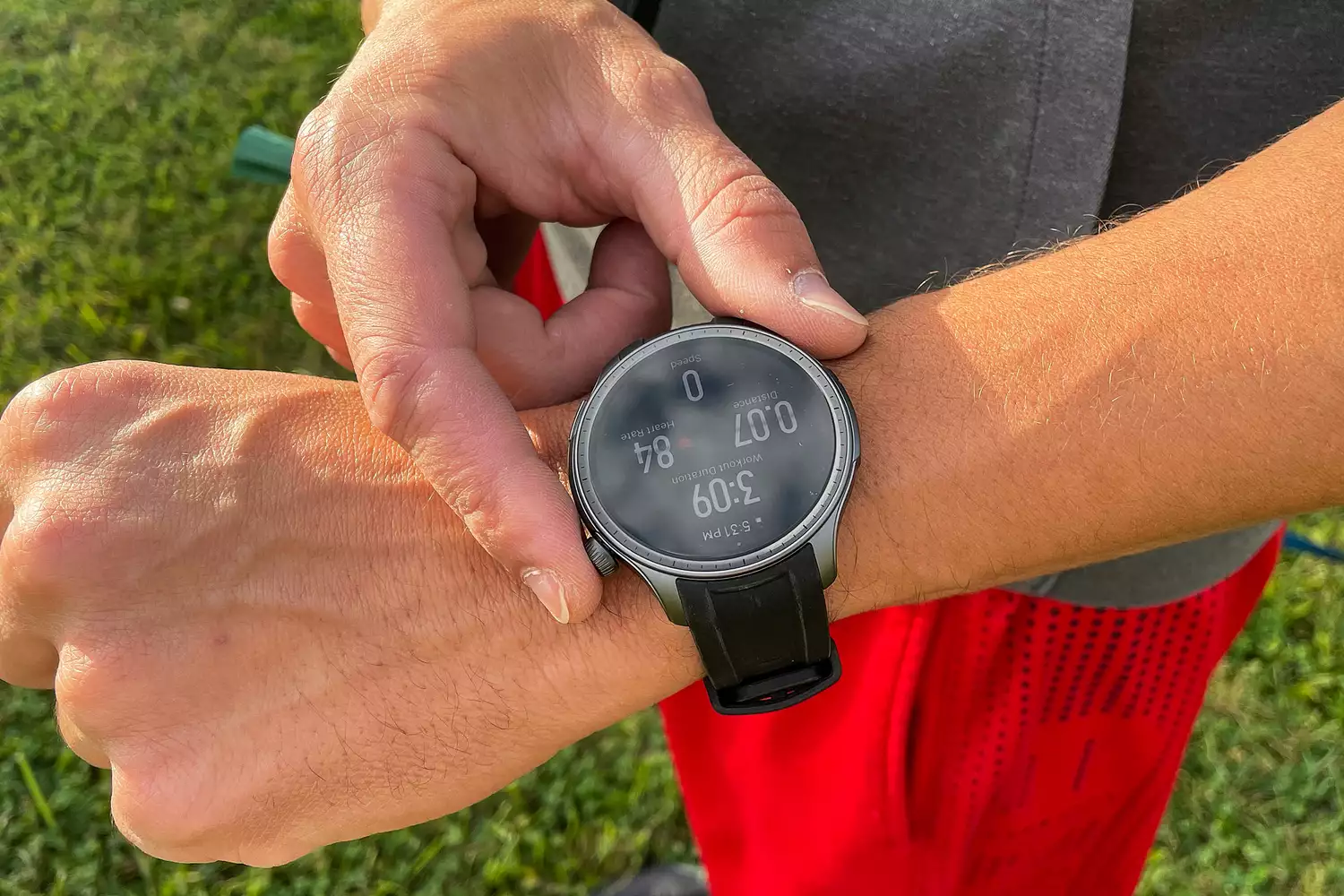 A person presses buttons on the side of the Amazfit Balance Smart Watch