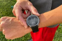A person presses buttons on the side of the Amazfit Balance Smart Watch