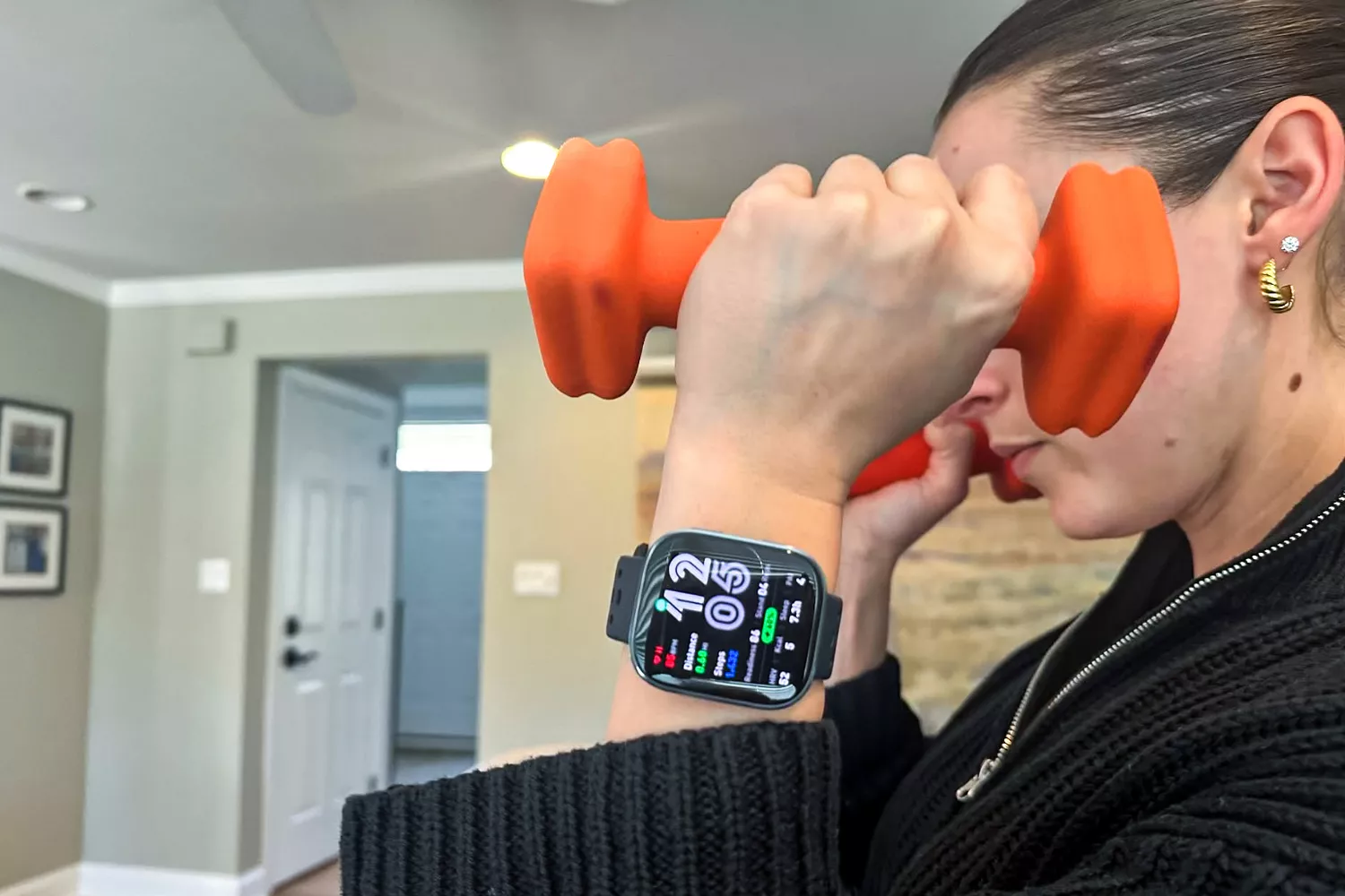 A person wears the Amazfit Bip 6 Smartwatch while lifting weights
