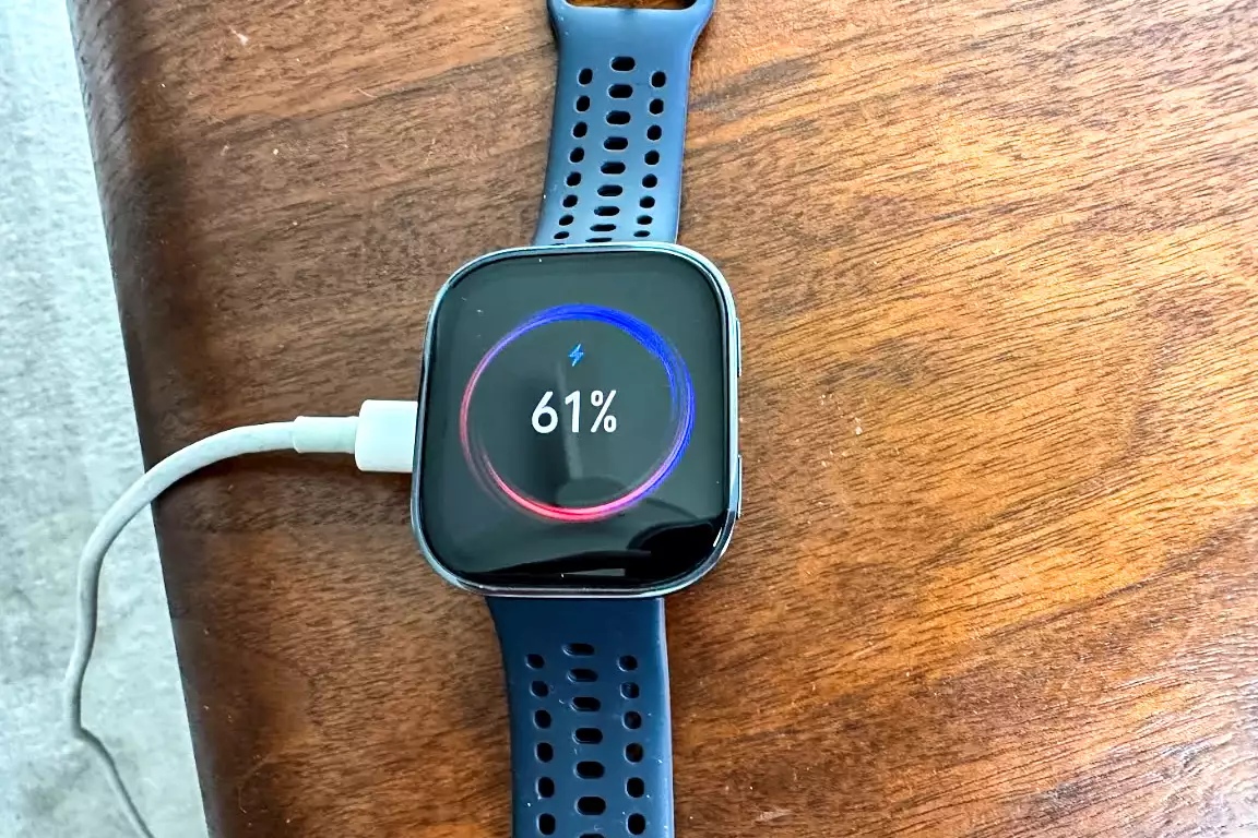 The Amazfit Bip 6 Smartwatch plugged in and charging
