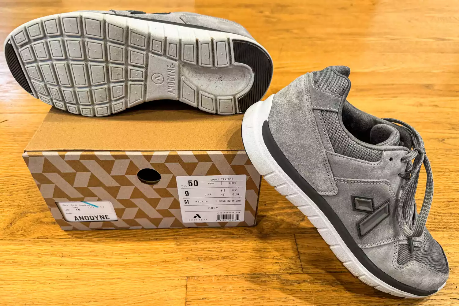 The Anodyne No. 50 Men's Sport Trainers posed around their box