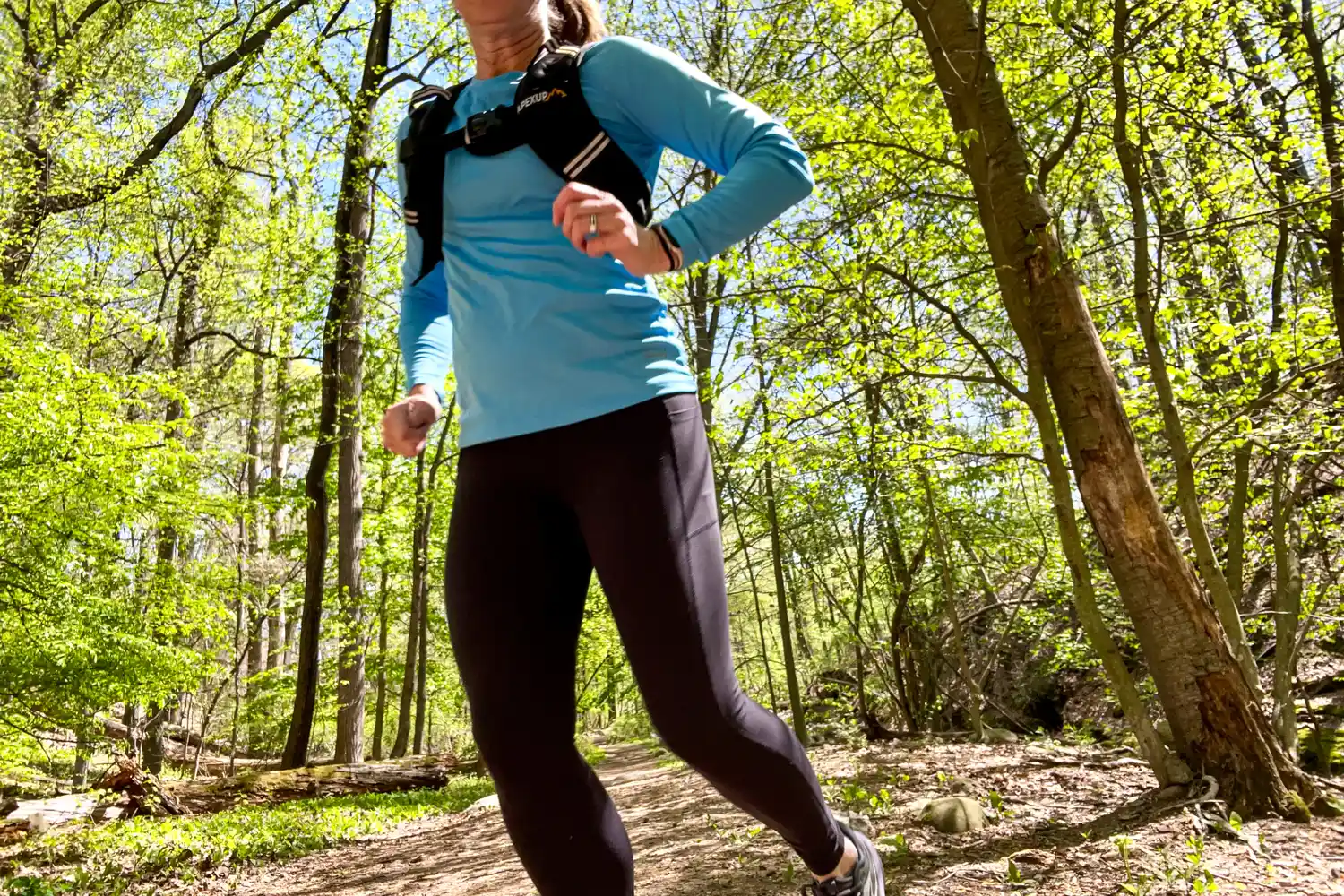 A person runs outside while wearing the APEXUP Weighted Vest