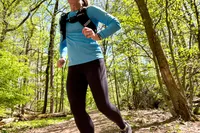 A person runs outside while wearing the APEXUP Weighted Vest