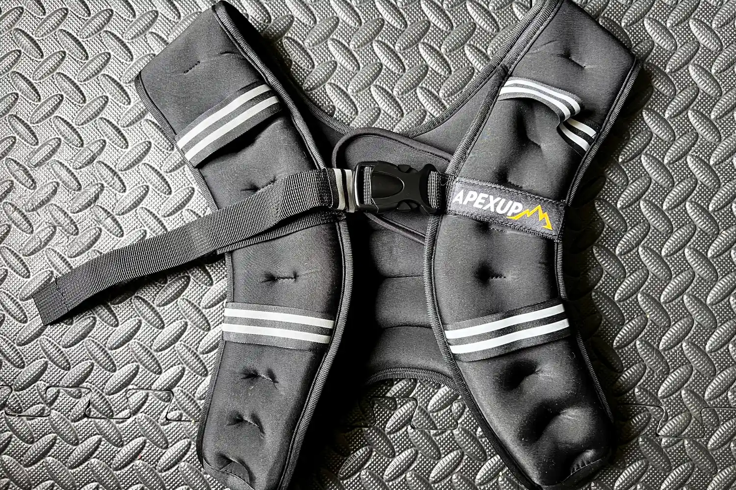 The APEXUP Weighted Vest on a gym floor