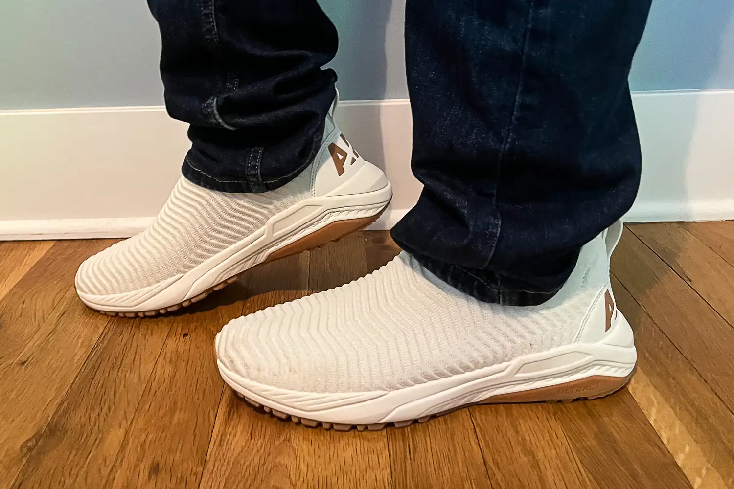 A side view of a person wearing the APL Men's TechLoom Travelers